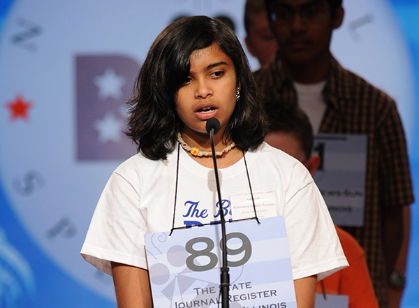 Aishwarya Pastapur preparing to spell a word at the microphone during the National Spelling Bee