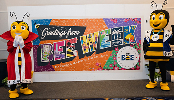 Bee mascots with "Greetings from Bee Week" mural